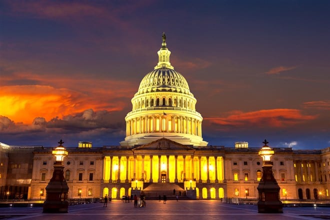 The United States Capitol building at sunset at night in Washington DC, USA