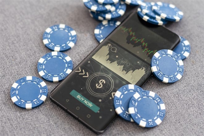 Blue poker chips on stock market chart background. High quality photo - stock image