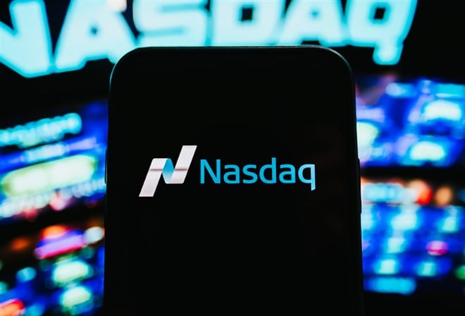 Photo of the NASDAQ logo on a black mobile phone screen.