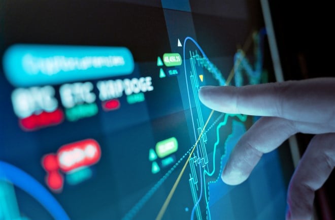 A man analysing virtual currency price charts on a screen, crytocurrency investment background.