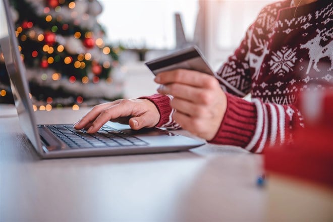 Woman shopping online at home - stock image