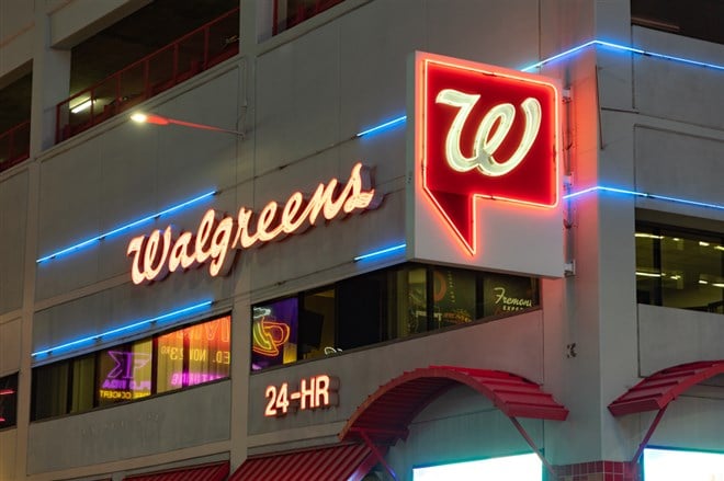 A picture of a Walgreens at night.