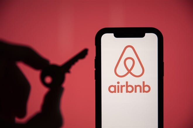 LONDON, UK - May 15 2020: Airbnb home rental logo on a phone with a key