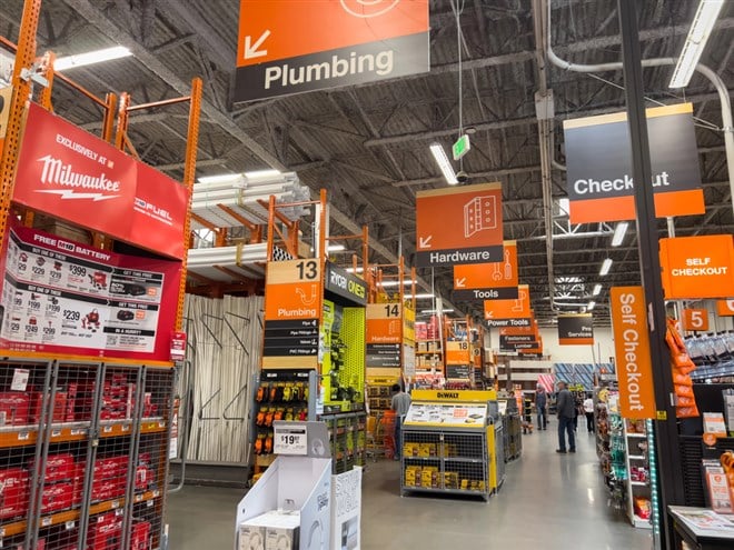 Broomfield, Colorado, USA-September 1, 2024-A well-organized view inside a home improvement store, featuring aisles dedicated to plumbing, hardware, and tools. Bright orange signage hangs from the — Stock Editorial Photography