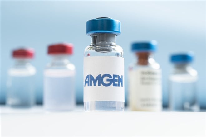 Vials of liquid on a white table and the logo Amgen, large pharmaceutical company. March 15, 2021. Barnaul, Russia.