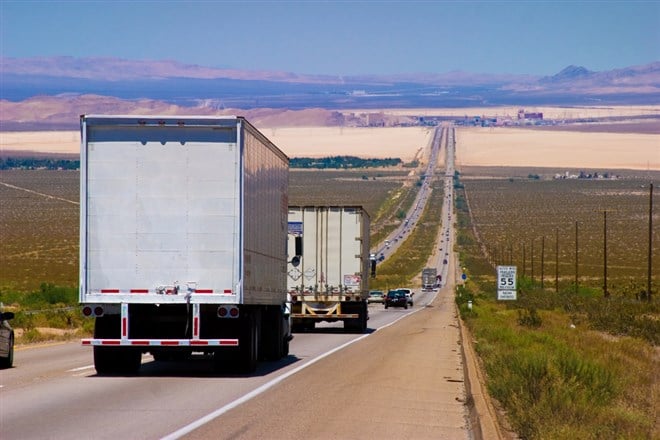 Delivery trucks on a highway. — Photo