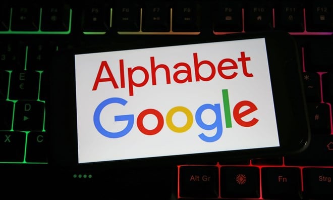 Viersen, Germany - July 9. 2023: Closeup of mobile phone on computer keyboard with logo lettering of Google Alphabet holding company