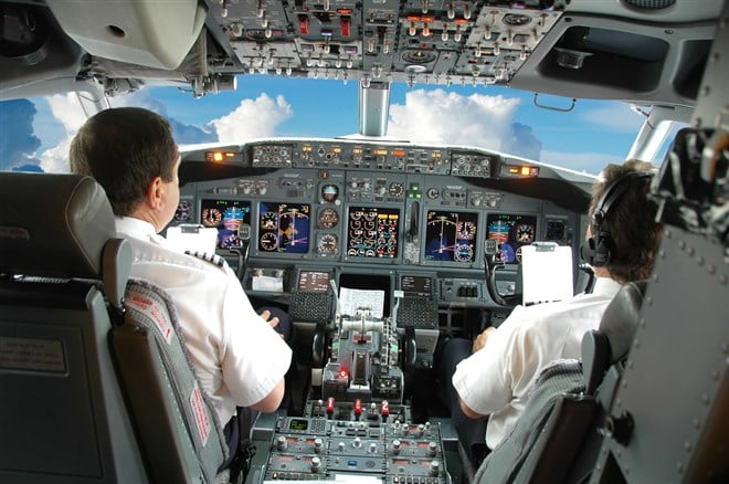 Photo of pilots at the flight deck control station.