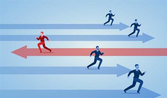 Photo of a group of businessmen running in one direction with arrows (in blue) and one businessman in opposite (with arrow) in red