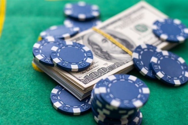 Poker chips and dollar Money bills on green cloth. High quality photo - stock image