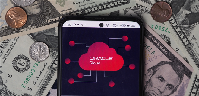 Bavaria, Germany - January 8, 2024: In this photo illustration, a Oracle Cloud logo seen displayed on a smartphone with United States Dollar notes and coins in the background. — Stock Editorial Photography