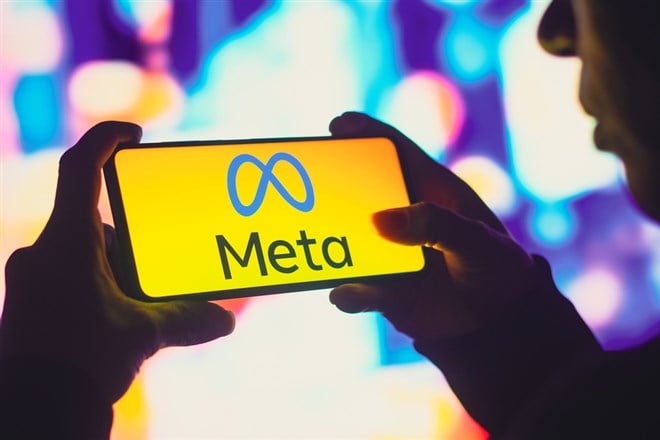 June 1, 2022, Brazil. In this photo illustration, a silhouetted woman holds a smartphone with the Meta Platforms, Inc. logo displayed on the screen