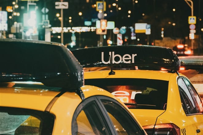 Taxi stand with Uber yellow cabs at night, Moscow, 31 Oct 2021