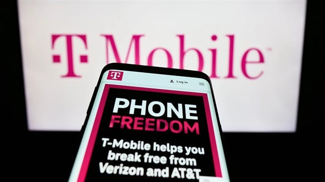 Stuttgart, Germany - 08-09-2023: Mobile phone with web page of telecommunications company T-Mobile US Inc. on screen in front of business logo. Focus on top-left of phone display. — Photo by T.Schneider