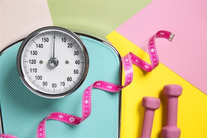 Scale, dumbbells and measuring tape on color background, flat lay — Photo