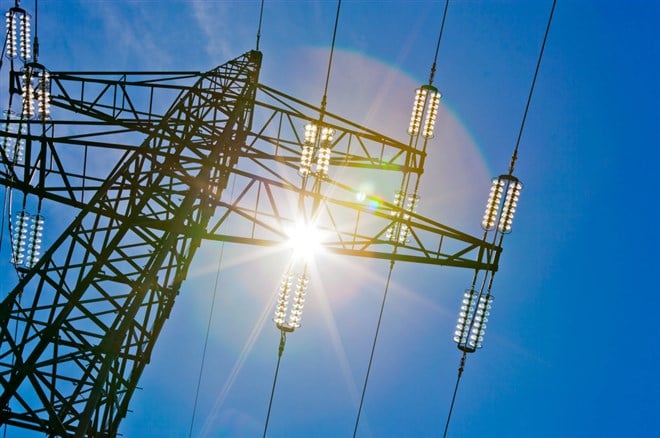 Power line with sun - stock image