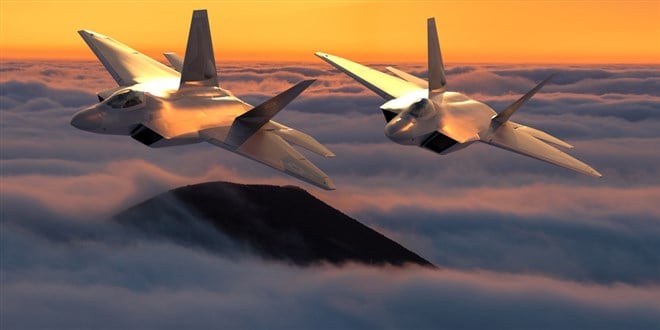 formation of the fifth generation :Lockheed Martin F-22 Raptor of the US Air Force in flight above the clouds