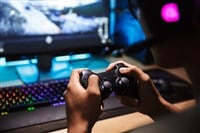 Photo closeup of playing video games; learn more about video game stocks on MarketBeat