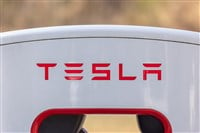 Electric car Tesla charging at supercharger station