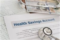 health savings account HSA concept with application form,dollar money, stethoscope, bank account on desk.