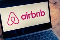 Airbnb logo displayed on computer laptop screen