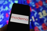 mobile phone screen with logo lettering of moderna pharma, stock market chart background