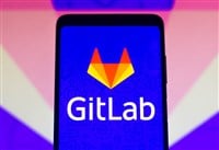 GitLab logo seen displayed on a smartphone and on the background