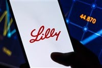 Eli Lilly logo on smartphone screen with stock market background
