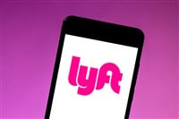 Lyft logo is displayed on a smartphone