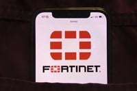 Fortinet Inc logo displayed on mobile phone hidden in jeans pocket