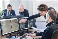 software developers working on desktop computer