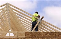 Carpenter setting Trusses for the roof of a house
