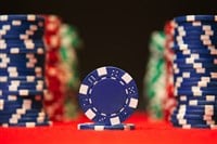 Photo of poker chips, with a blue one in front, symbolizing blue chip stocks.