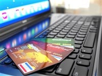 Online purchase. Credit card on laptop keyboard