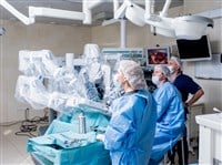 surgical robot in operating room with surgeons