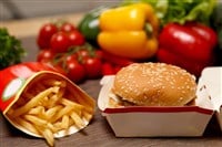 BigMac and french fries on a healthy background — Stock Editorial Photography