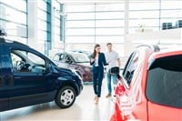 Sales manager showing car to customer — Photo