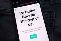 Robinhood cryptocurrency exchange website displayed on smartphone hidden in jeans pocket