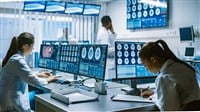 Team of Professional Scientists Work in the Brain Research Laboratory Surrounded by Monitors Showing CT