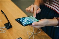 The buyer looks to buy a new modern iPhone X in the official Apple store in Berlin in Germany.