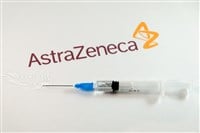 AstraZeneca Covid-19 vaccine concept. Close-up of a syringe and and, the AstraZeneca company logo in the background.