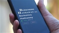 Berkshire Hathaway Warren Buffett stock information on smartphone screen