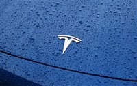 tesla emblem on blue car