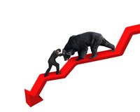 Photo of a businessman pushing against a bear trying to walk on a red downward trend line.