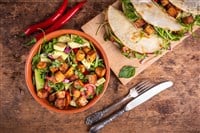 Vegetable salad with fried tofu in a bowl and vegan tacos with waxes, tofu and hot peppers, top view - vegetarian cuisine