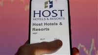 Host Hotels logo and stock on smartphone