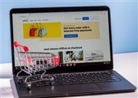 Shopping cart in front of computer screen for Affirm buy now pay later app — Stock Editorial Photography