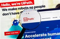 Montreal, Canada - March 08, 2020: UiPath official website and logo under magnifying glass. UiPath is a global software company that develops a platform for robotic process automation. — Stock Editorial Photography