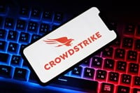 Close up view of the smartphone on neon keyboard with crowdstrike logo — Stock Editorial Photography