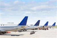 Tails of some airplanes at airport during boarding operation — Photo